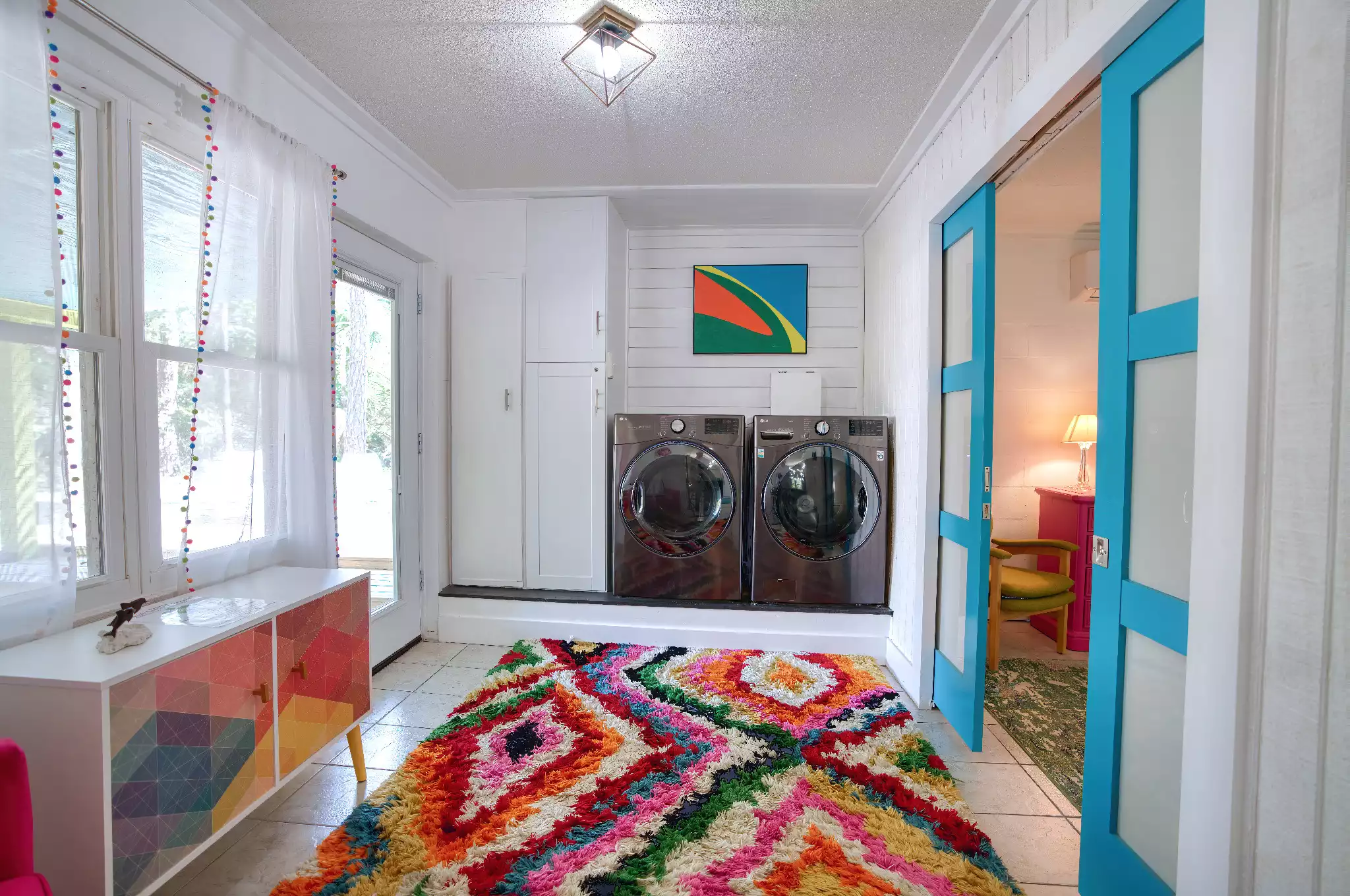 Laundry Room - Blue doors lead in to the Palm Suite - The Salty Mermaid - Pool, Hot Tub, & Dog Friendly - St George Island