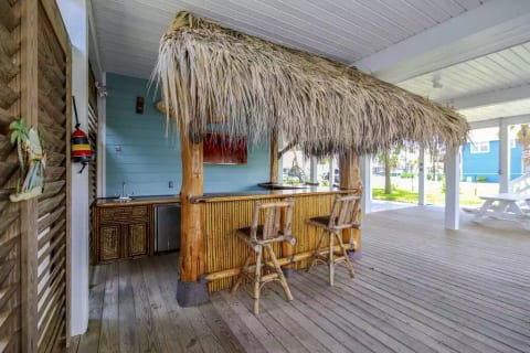 Under the house is THE place to be on a hot day. The shade and breeze cool you off on the hottest days. There is a TV, fridge and ice maker in the Tiki Bar. Why go upstairs to fix a drink? Stay below and have everything you need at your fingertips.