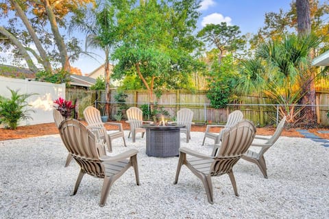 Shell path leads to the fire pit amid lush, tropical landscaping.