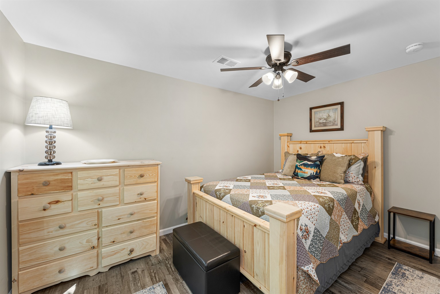 The primary bedroom has a queen bed and a closet. - Coyote Cabin - Fort Payne