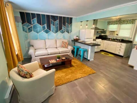 Open living room and kitchen with breakfast bar seating.