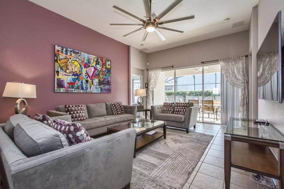 Living room with new ceiling fan and view of saltwater pool.