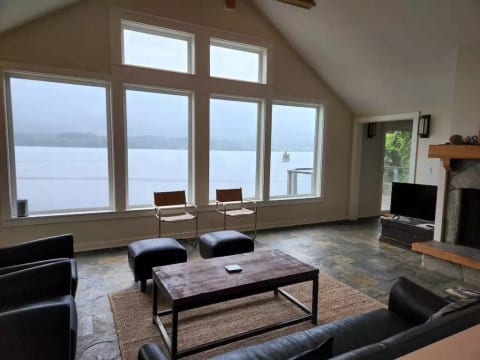 You are living on the water with beautiful fireplace, vaulted ceilings, and slate floors!