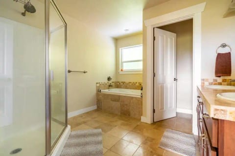 Private master bath with double sinks and separate toilet.