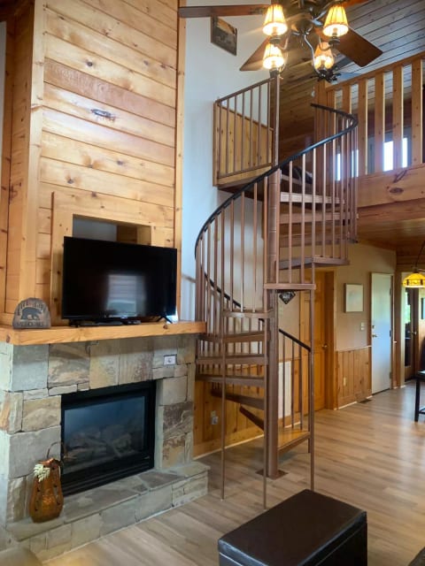 Main level living room with fireplace and tv