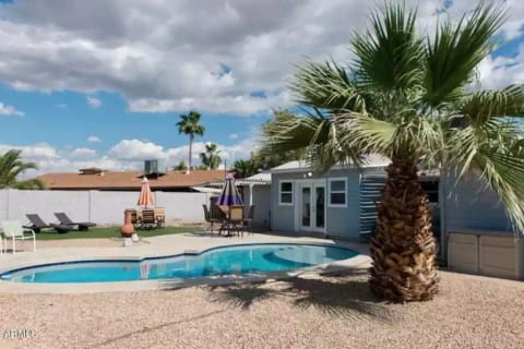 Backyard Oasis with clear sparkling pool and yard