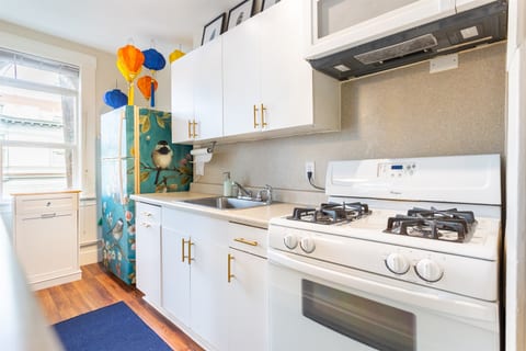 Step into a fully equipped kitchen where culinary creativity meets artistic flair. From fun decorations to a customized painted fridge, this space is as unique as it is functional.