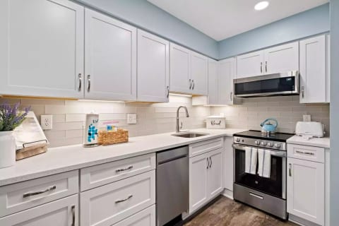 Our newly renovated kitchen! New appliances, quartz countertops, frosted glass backsplash!