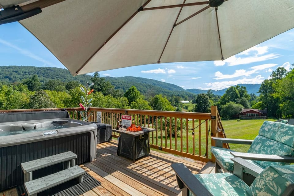 Pop open the umbrella to enjoy beautiful views in the shade on comfy adirondack chairs.  In the evening, the fire pit and hot tub are perfect after a long day of golfing, shopping the River Arts District or tubing down the French Broad River.