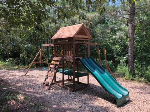 Two slides, two swings and an acrobar, monkey bars, rock wall and a hammock