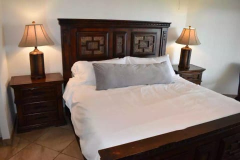 Master bedroom with a king sized bed and direct access to the patio.