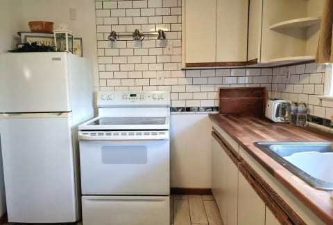 tile kitchen with butcher block counter top. https://sanctuaryoftheswan.com Wellness whole home hotel. 4 entire homes in nature. No parking lot views. BEST extended stay in Berks County, PA. swanhotel sanctuaryhotel extenedstayhotel extendedstay monthlyhotel longtermhotel travelnurses rn exelon
