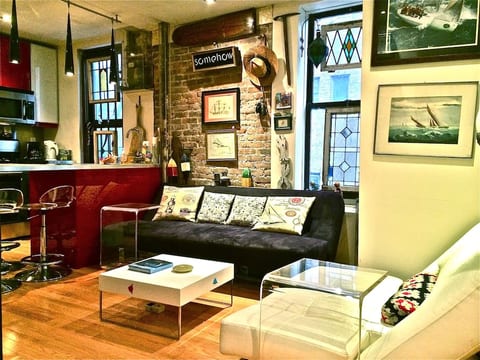 Living area and kitchen with island. This couch is also a fold out sleeper for additional guests