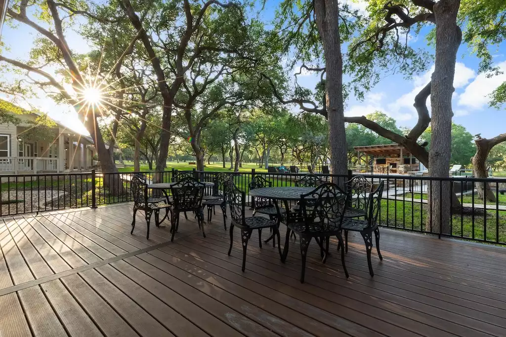 This spacious deck has seating for 12 and is great for outdoor dining. - Main House at Whispering Oaks Estate - Dripping Springs