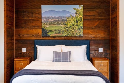 Salvaged Redwood wall surrounds the comfy Queen Size bed