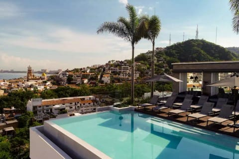 Heated infinity edge pool with single and double loungers. Umbrellas and roll out awnings are available for when you'd like a little more shade.