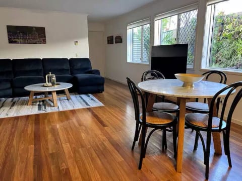 Large living area including extremely comfortable lounge, television and dining table
