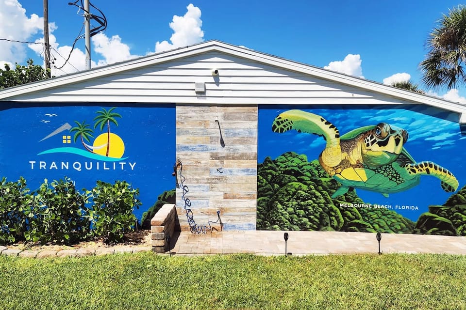 This stunning mural awaits you as you head to the outdoor shower after a day at the beach.