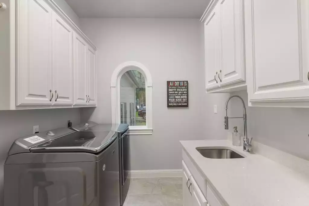 Laundry room equipped with Laundry Detergent, Pool Towels and Extra Linens. - Main House at Whispering Oaks Estate - Dripping Springs