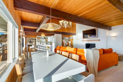 Enjoy gathering for a meal from the table with seating for 8 and a stunning waterfront view, listening to a record in the kitchen or watching a movie on the 65” Smart TV from the extra large sleeper sectional by the electric fireplace.
