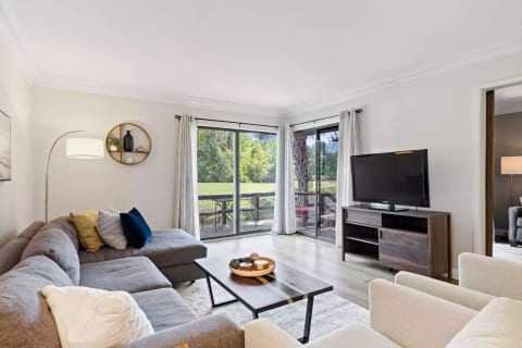 Comfortable, stylish living room with sliding glass doors to back deck