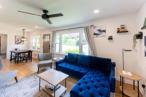 This is the main living room for our AirBnB! The 55" smart-TV is complimented by the cozy sectional, stylish chairs and lots of natural light!
