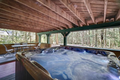 Relax in the Hot Tub while staring up at the huge evergreen trees