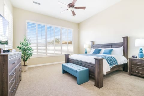 Master Bedroom - King bed covered in freshly laundered linens and a throw blanket. There is a dresser and smart tv with access to streaming services. En-Suite bathroom with tub, shower, double vanity, and walk in closet. A variety of sleeping pillows, blankets, and luggage racks are kept in the closets if needed.