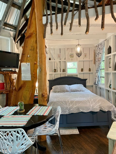 Queen bed with loft above in the treehouse