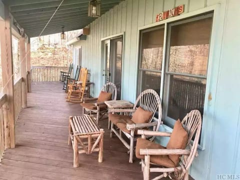 Spacious deck nestled in the woods with long range mountain views year round.
