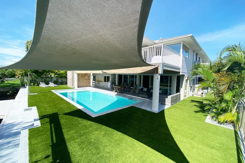 Back of house - heated pool, sun loungers, sofa set, teak patio table & chairs. pool sink. outside hot/cold shower. shade sail. artificial grass (great for kids). Huge game room, design furniture, hurricane impact windows, super-stocked/pro kitchen!