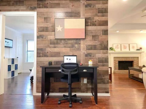 Modern office space with a comfy desk, chair, and black mat that will allow you to work and study during your leisure time.