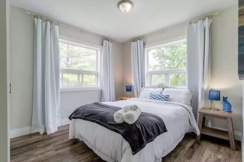 Beautiful Bedroom with comfortable new queen size bed, views of the lake from both windows.