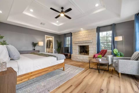 Bedroom 1: Downstairs primary. This bedroom comes with an attached ensuite bathroom and 42" smart TV. You'll love spaciousness of the KING size bed. You're in for a restful snooze with blackout curtains and alarm clock/sound machine combo