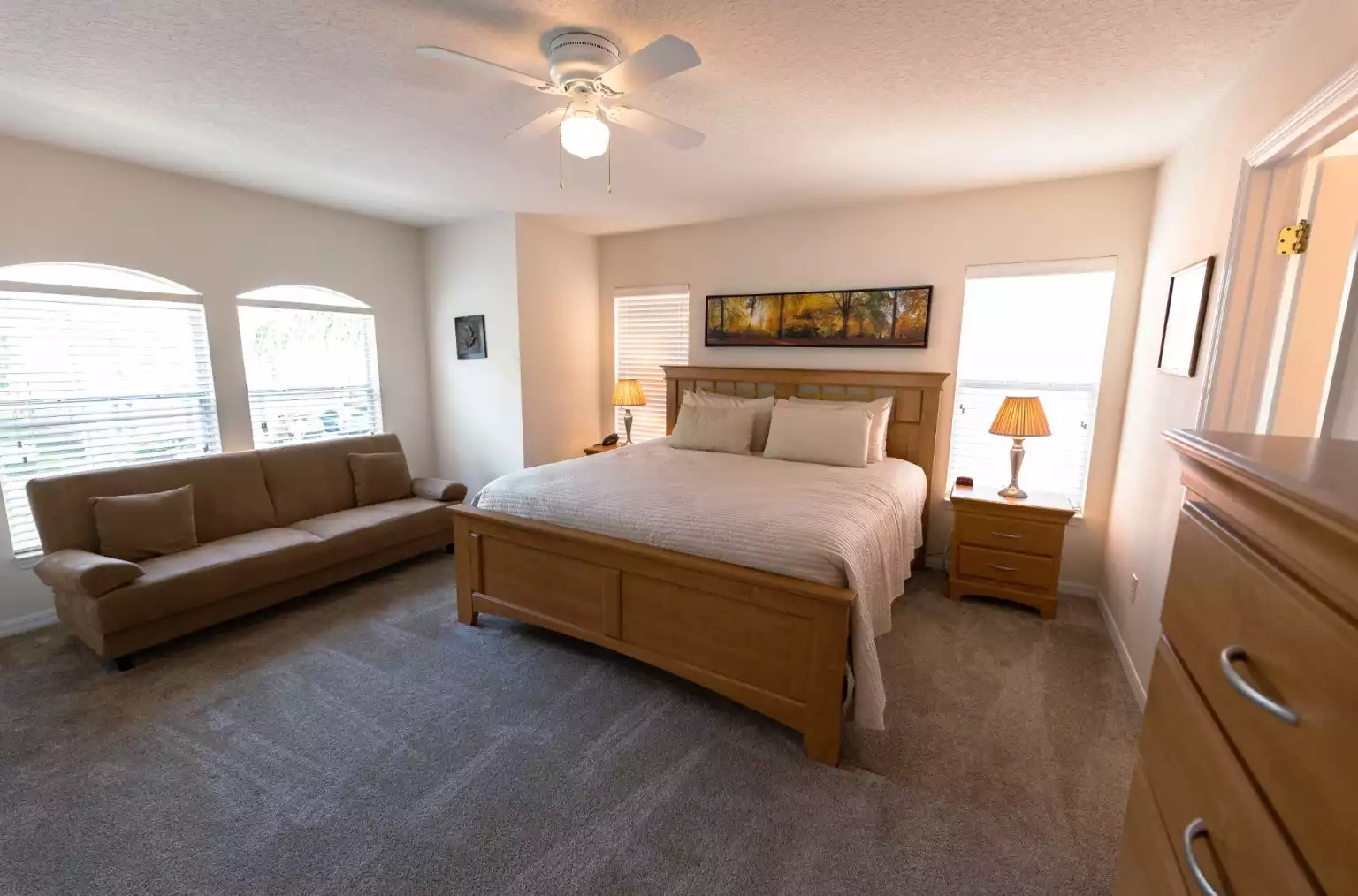 Master bedroom with king-size bed, couch, walk-in closet, and Smart TV. - Cosmos Villa - Davenport