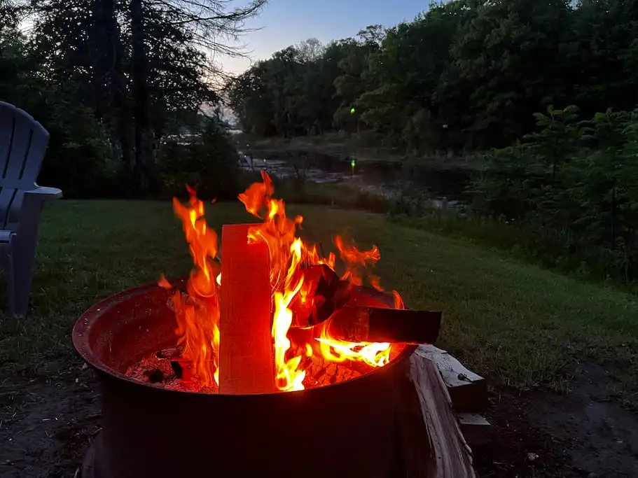 Relax around the fire pit in the evening! - Serene Port Bay Cottage - Wolcott