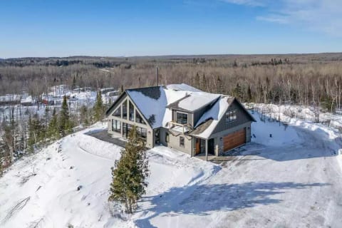 Aerial view of the house . It sits on top of your private bluff with beautiful views of Lax Lake and the rolling hill sides.