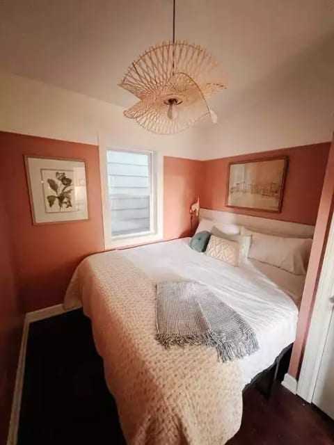 King size bed nestled into this cozy and quaint bedroom in the front of the house.