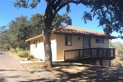 Back side with back door and small deck with ramp