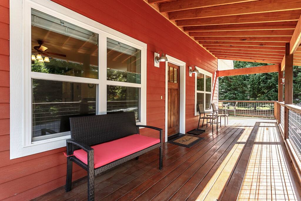 The front porch and entry door into your home away from home. Beyond the trees is another vacation rental owned by us. - River Rock Cabin - near Hendersonville, NC - Horse Shoe