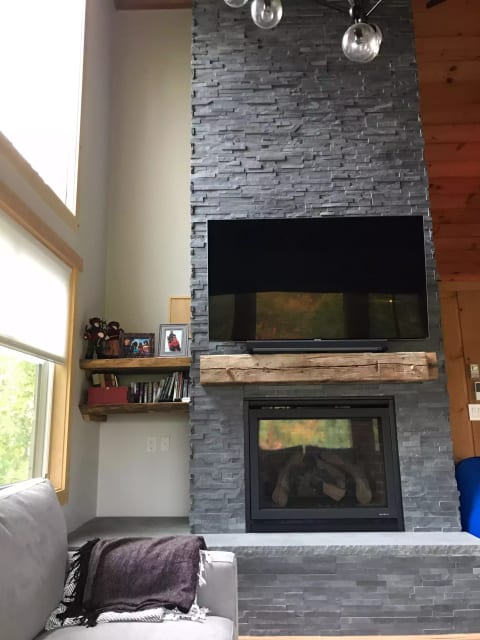 beautiful stonework with gas fireplace and smart TV