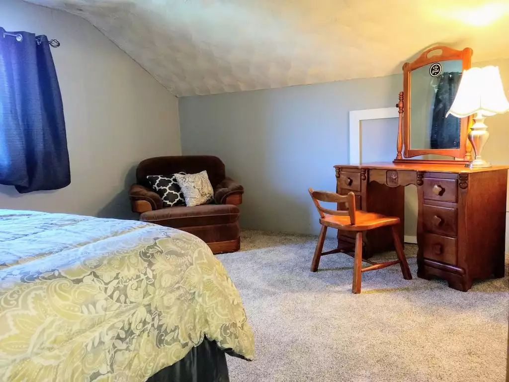 Queen's room - cozy chair and vanity - Peaceful Acres Vacation Rental - Hesston