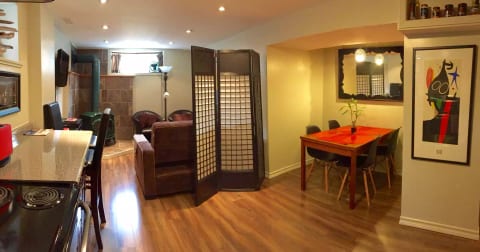 Open concept kitchen, dining living area with shoji screen for privacy for sofa bed