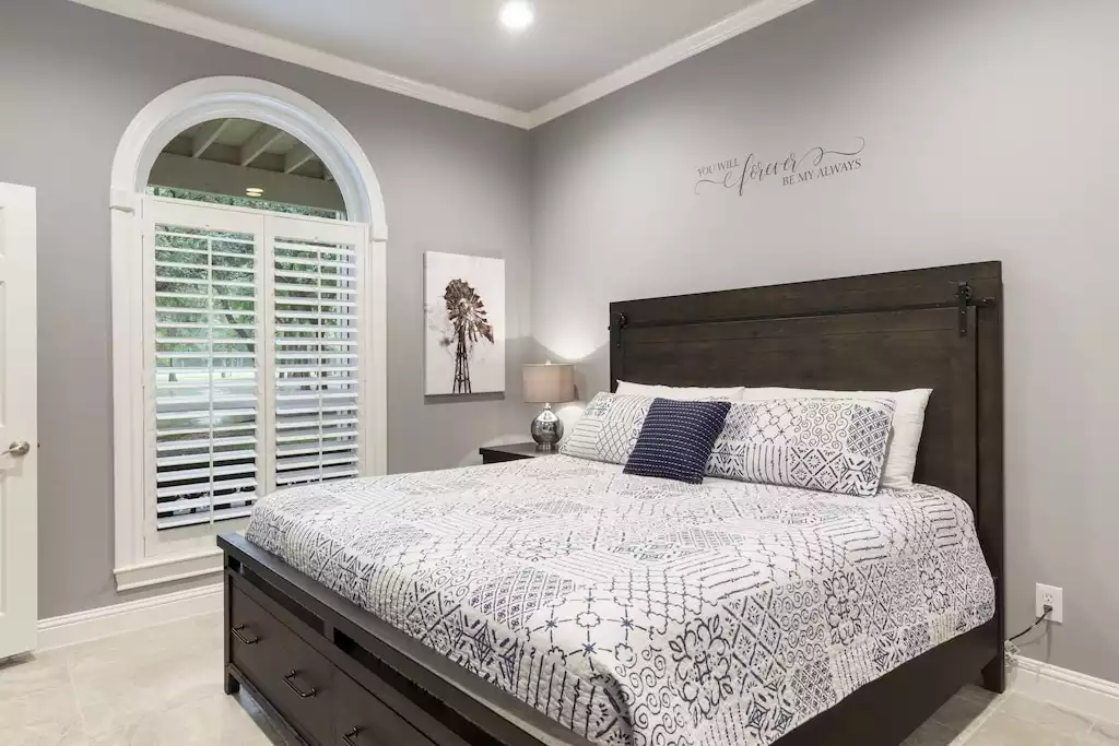 Bedroom #2, the second primary on the first floor has a king bed and Smart TV. - Main House at Whispering Oaks Estate - Dripping Springs