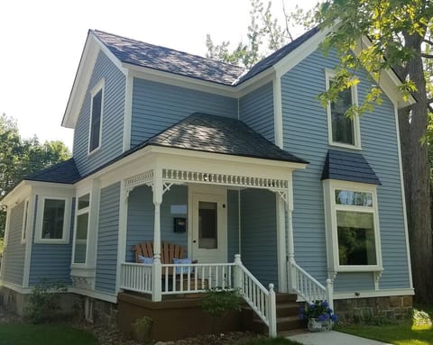 Front of house with cozy front porch area to sit on.