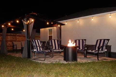 Patio area with gazebo, furniture, and fire pit