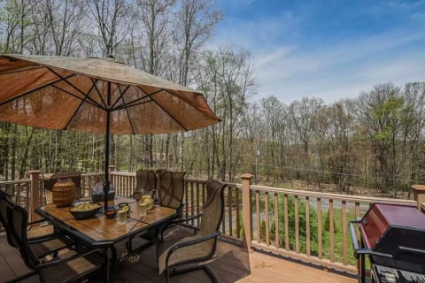 Spacious eating space with gas grill and beautiful Mountain View’s. Grilling utensils are located in the kitchen.
