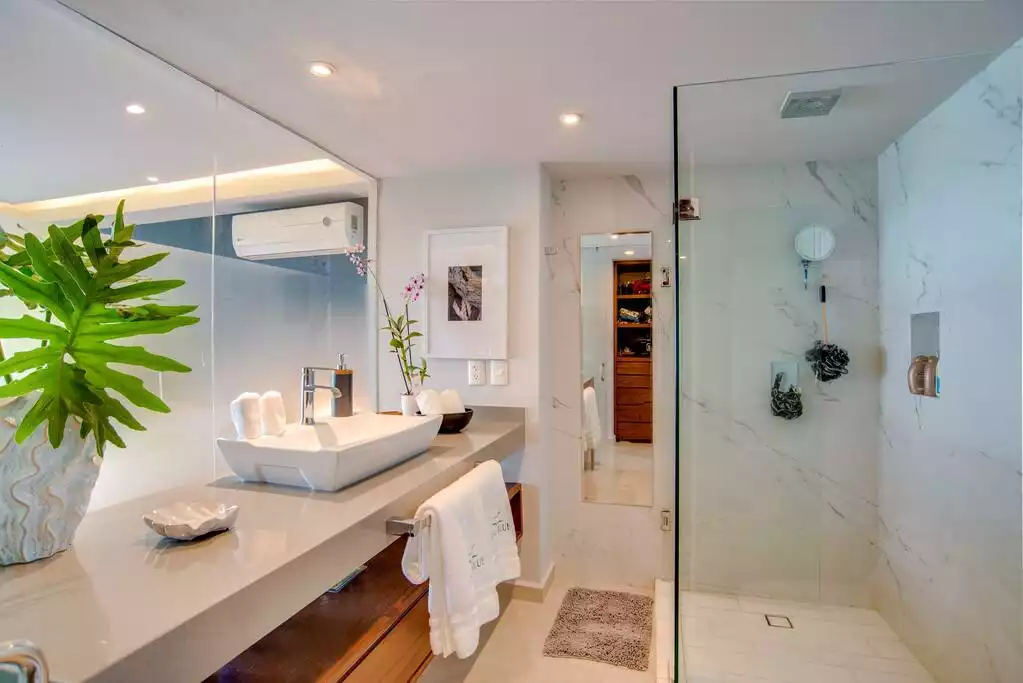 Bath accents include embroidered towels, and dual shower heads.