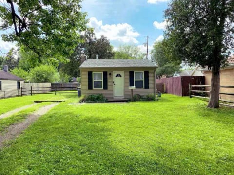 Front of the little house. The lot it sits on is a double lot. There is a Ring doorbell camera on the front next to the front door that is love 24/7.