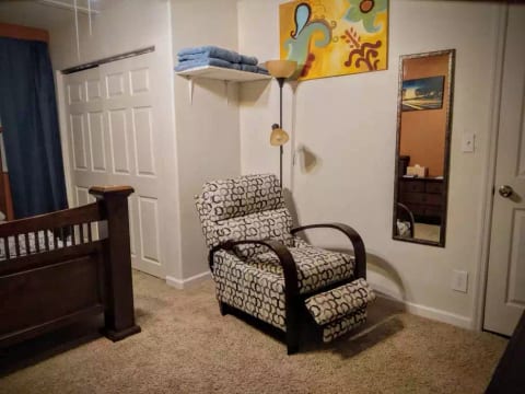 Fresh towels, a reclining chair, and a luggage rack for your convenience.